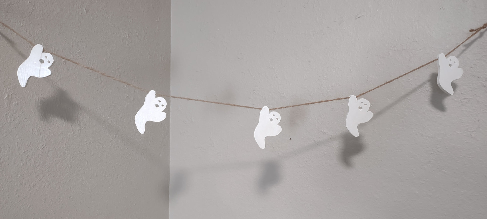 White, wooden Halloween ghosts. Five Ghosts on Five feet of brown twine.